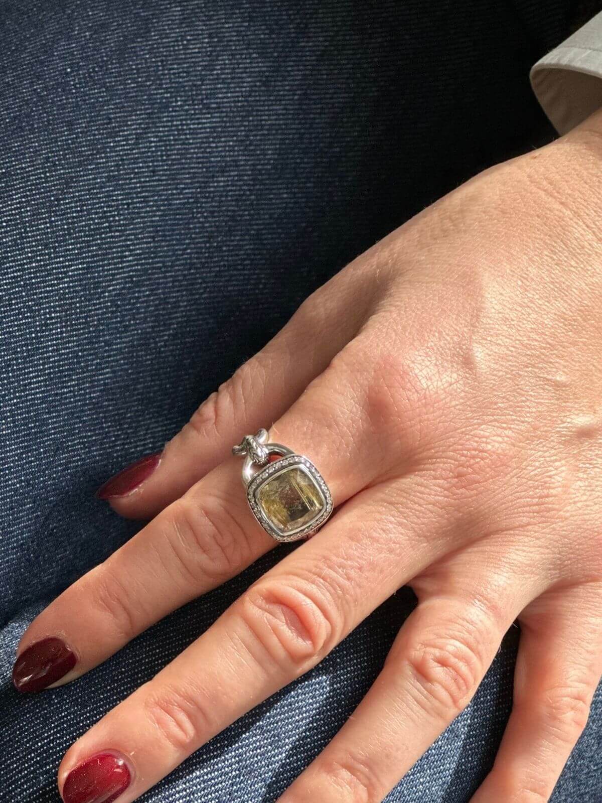 John Hardy quartz ring on model hand on jeans