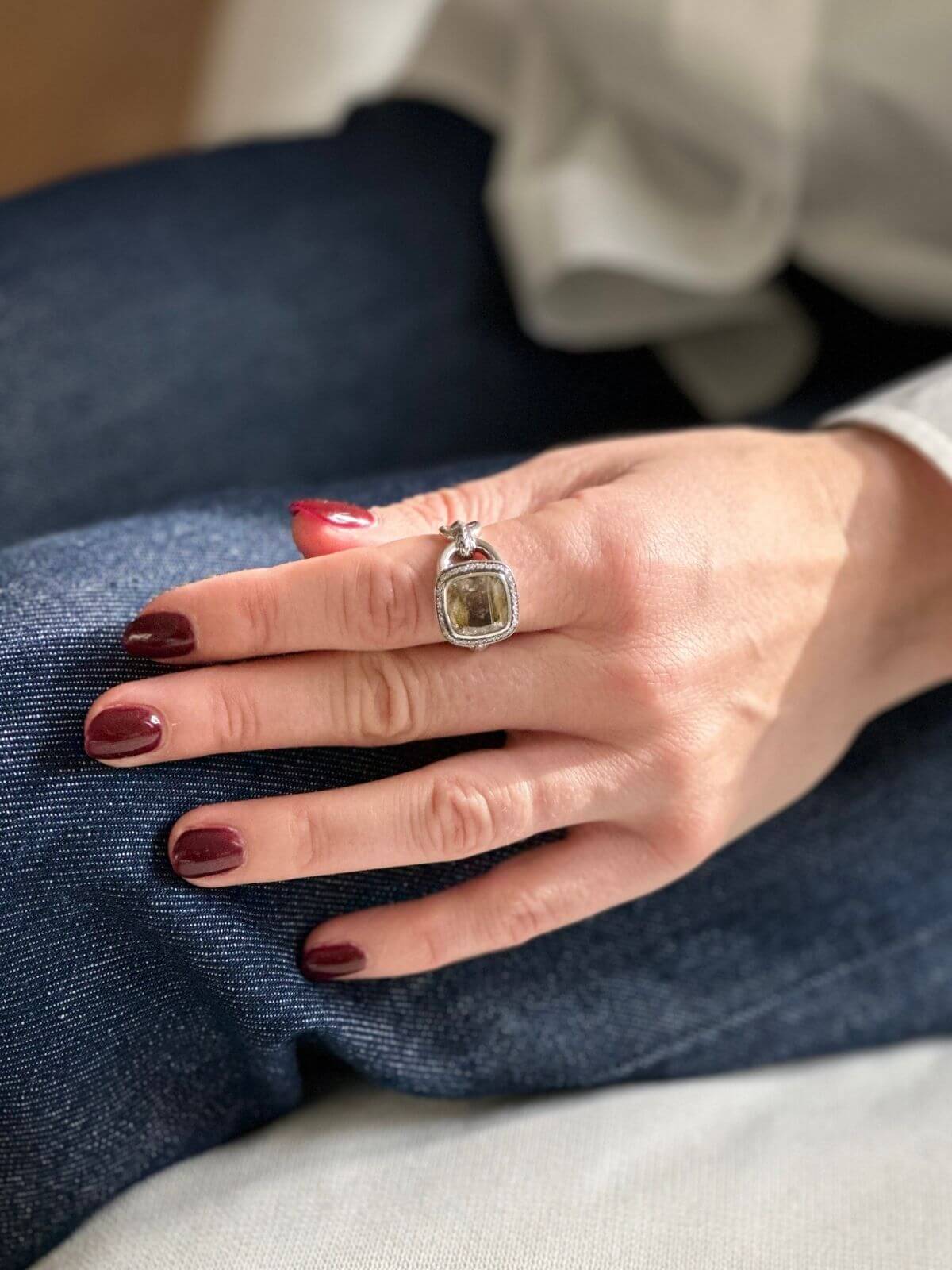 John Hardy quartz ring on model hand on jeans
