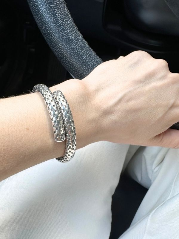 Louise Row Studio featuring John Hardy Dot bracelet silver with dots on arm holding steering wheel.