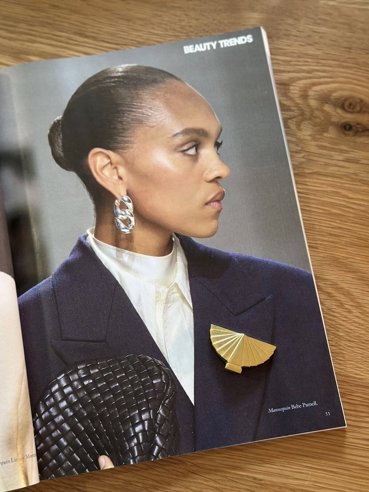 Louise Row Studio vintage Karl Lagerfeld gold fan brooch on magazine photo.