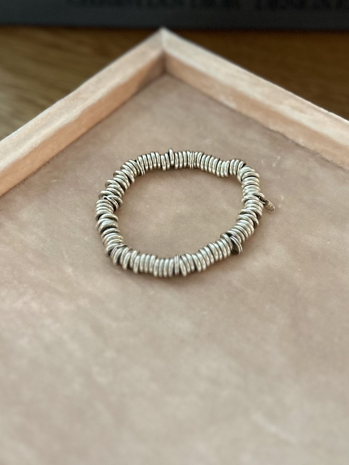 Silver Link of London Sweetie bracelet on pink background