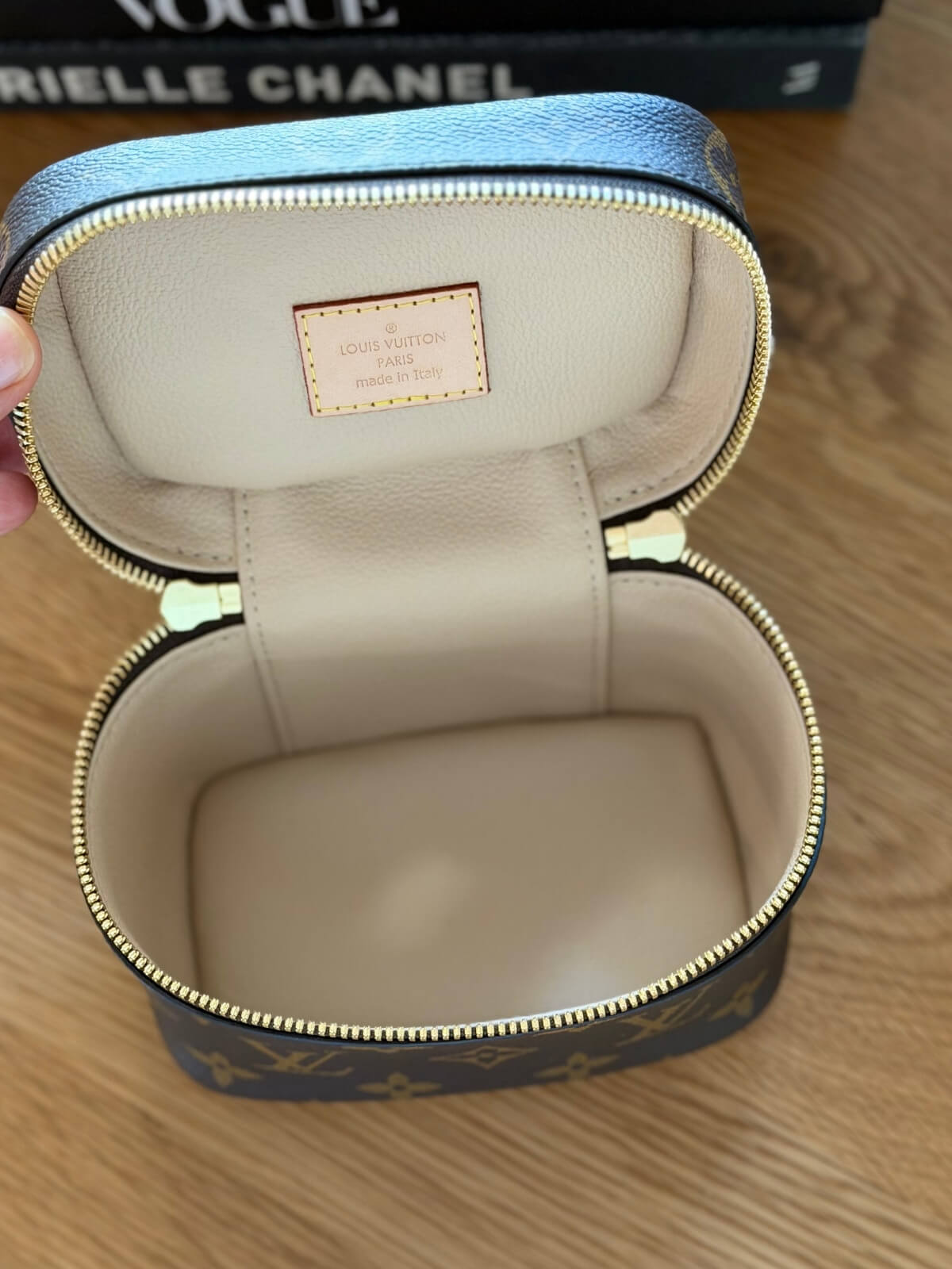 Louise Row featuring Louis Vuitton Nice Nano Vanity case on table with books
