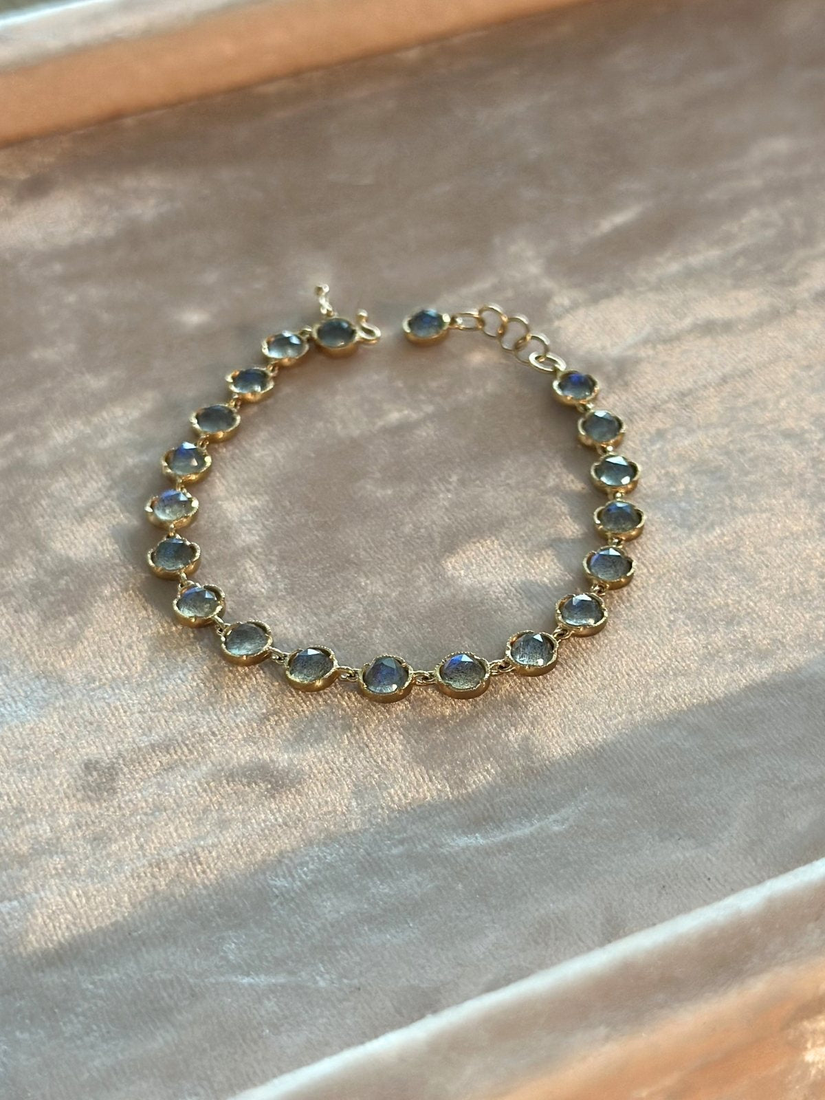 Louise Row Studio featuring custom Labradorite bracelet on pink pad. 