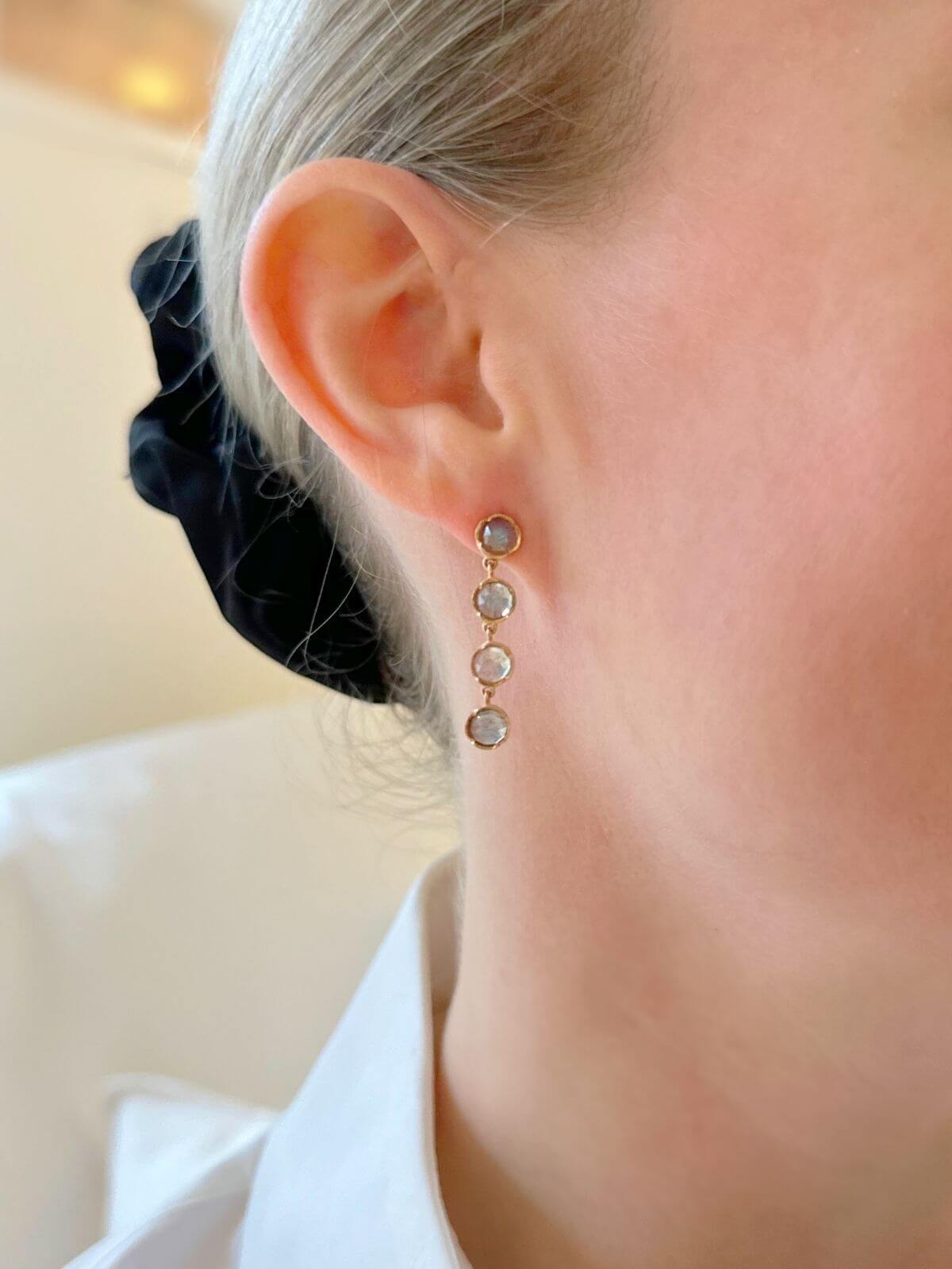 Close-up of an ear wearing a set of earrings with a blurred background