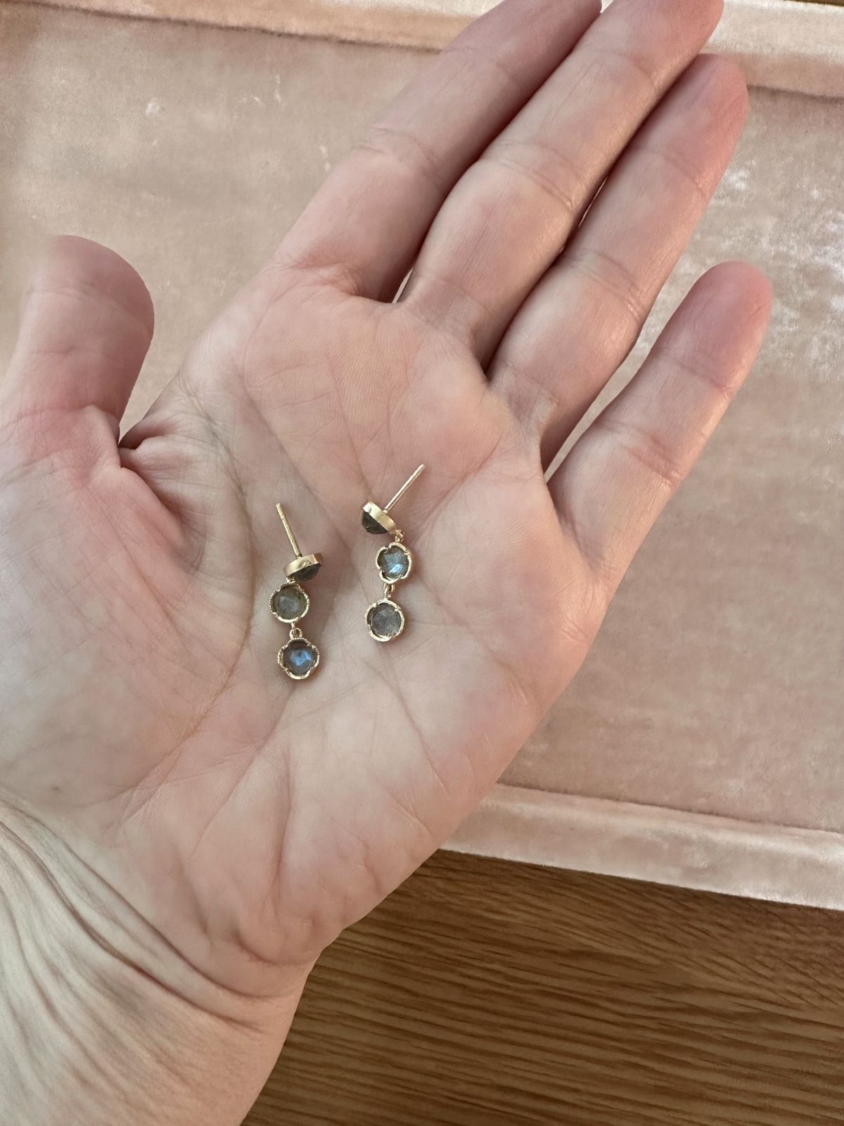Louise Row Studio 18K labradorite Gold earrings with gemstones held in a hand against a neutral background