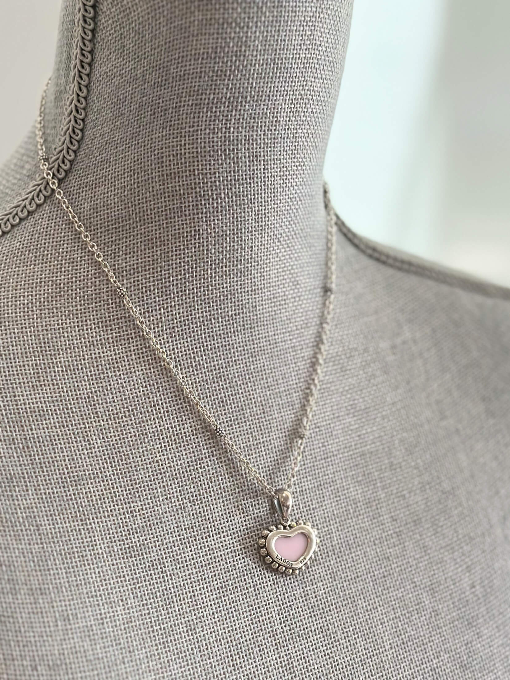 Louise Row featuring Lago pink ceramic heart necklace on grey mannequin