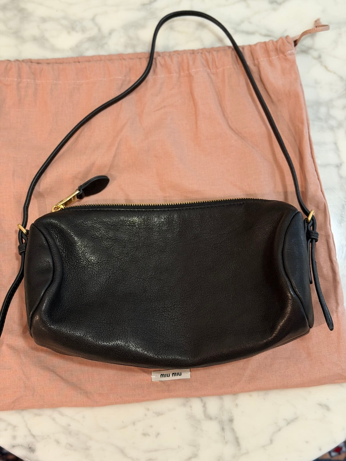 Louise Row featuring Miu Miu Nappa Black shoulder bag on table with books