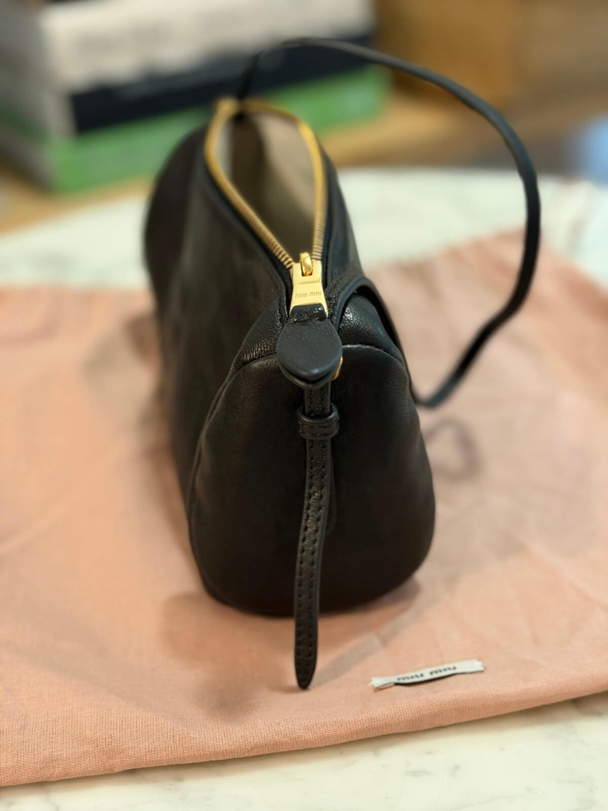 Louise Row featuring Miu Miu Nappa Black shoulder bag on table with books