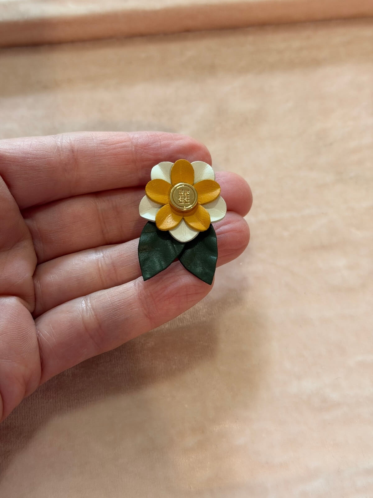 Louise Row featuring Miu Miu leather flower pin on hand