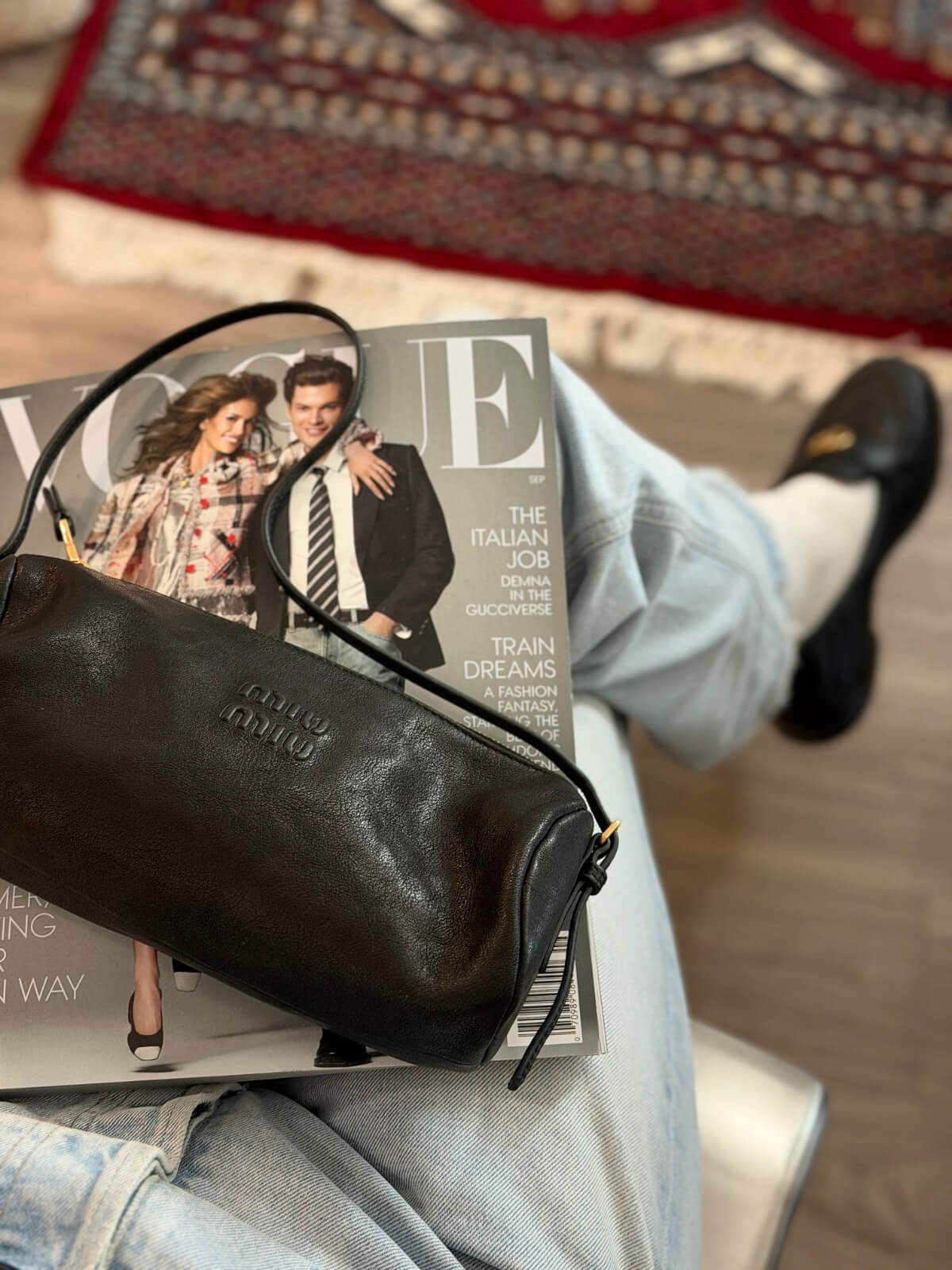 Louise Row Featuring model with Miu Miu bag on lap