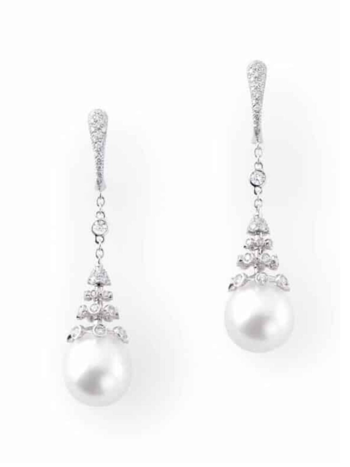 Pair of pearl earrings with silver accents on a white background