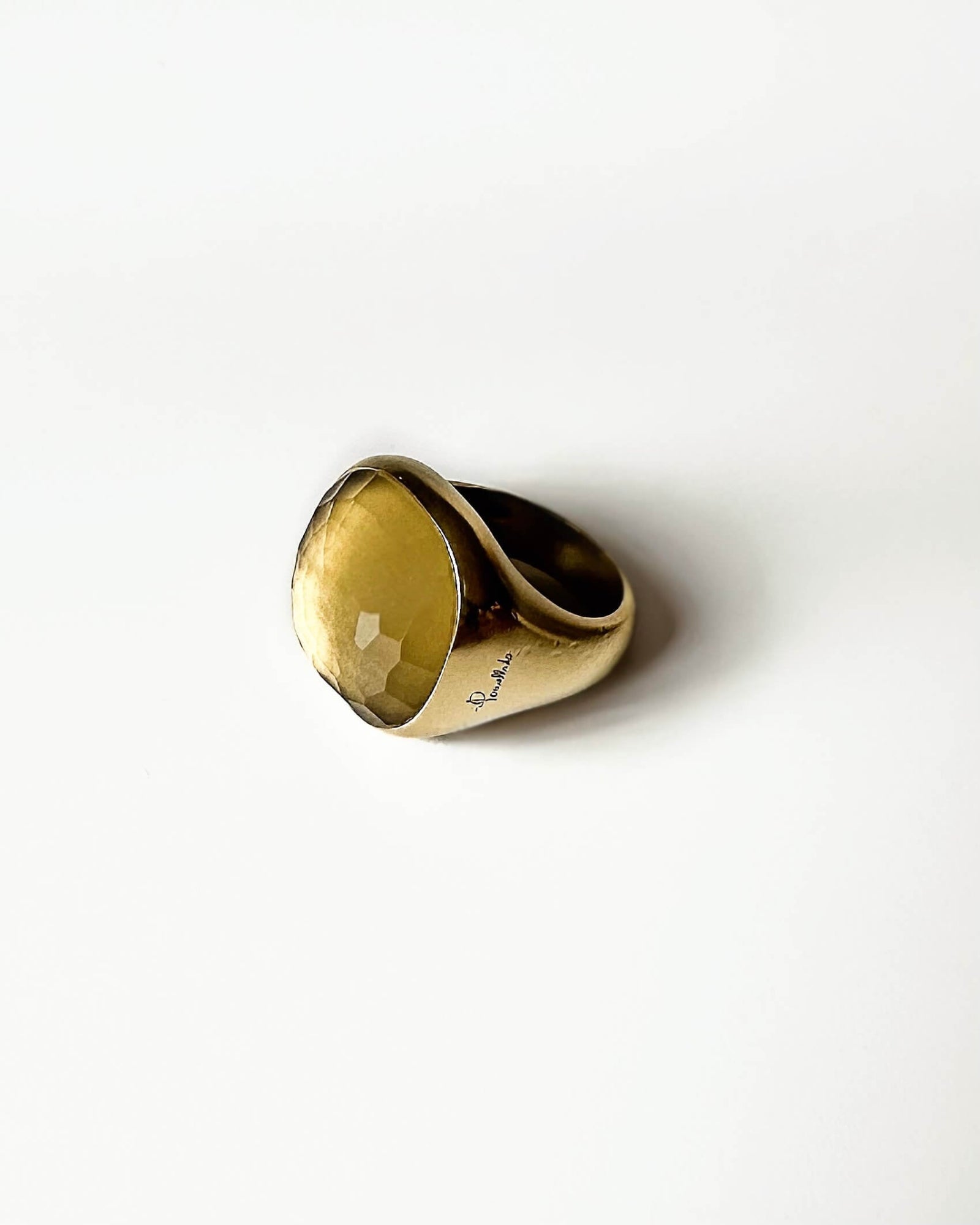 Gold ring with citrine stone on a white background