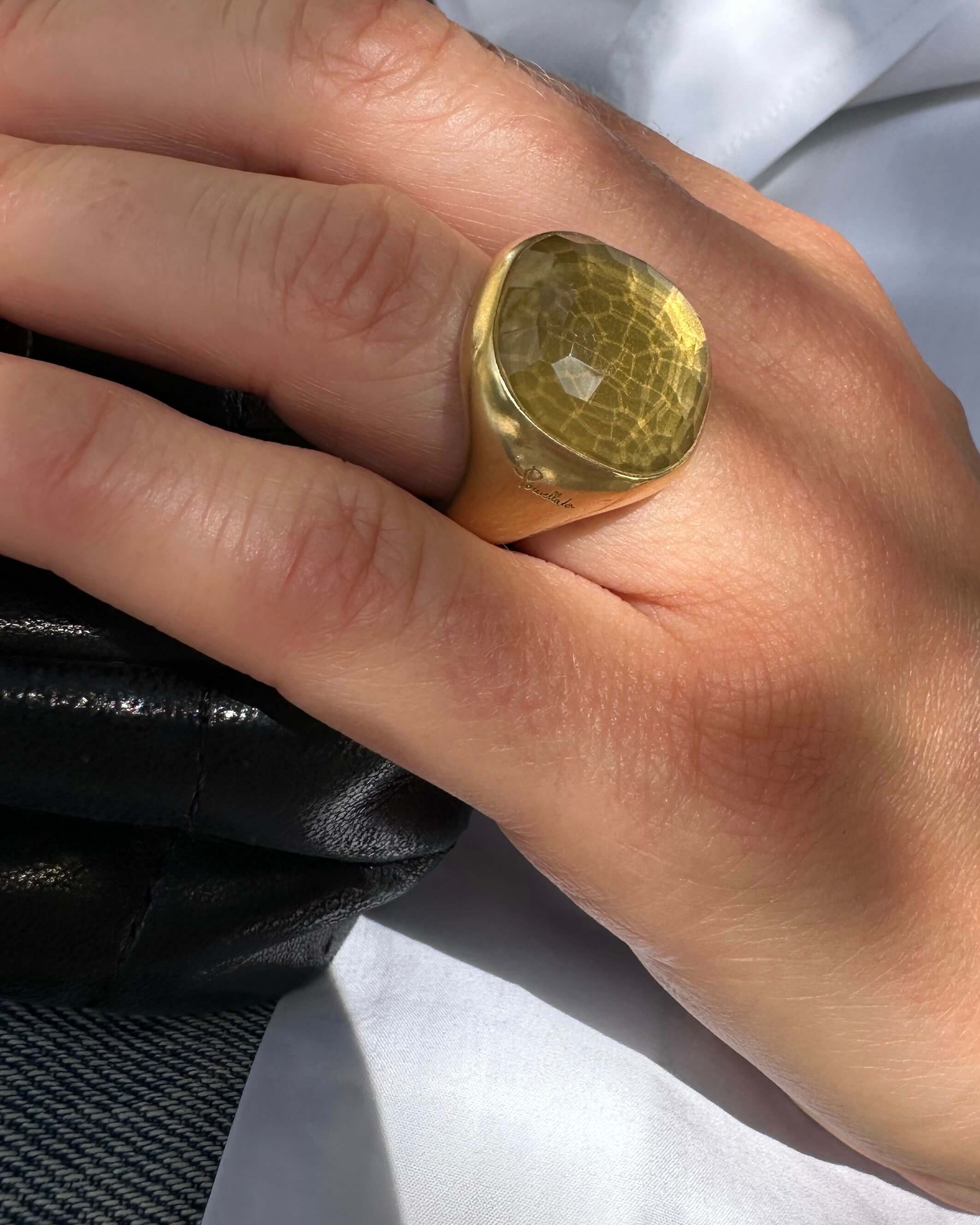 Gold ring on a finger with a blurred background