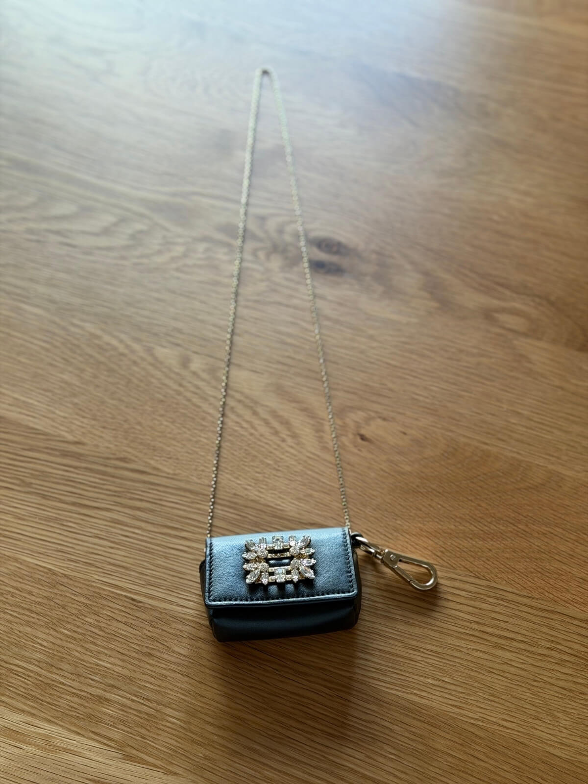Louise Row featuring Roger Vivier crystal pouch bag on wood table