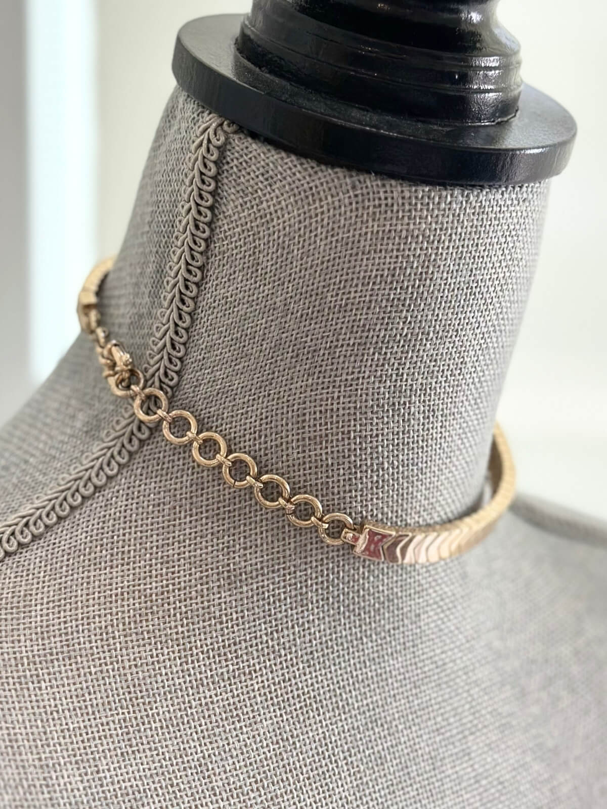 Louise Row featuring Roxanne Assoulin gold choker on grey mannequin