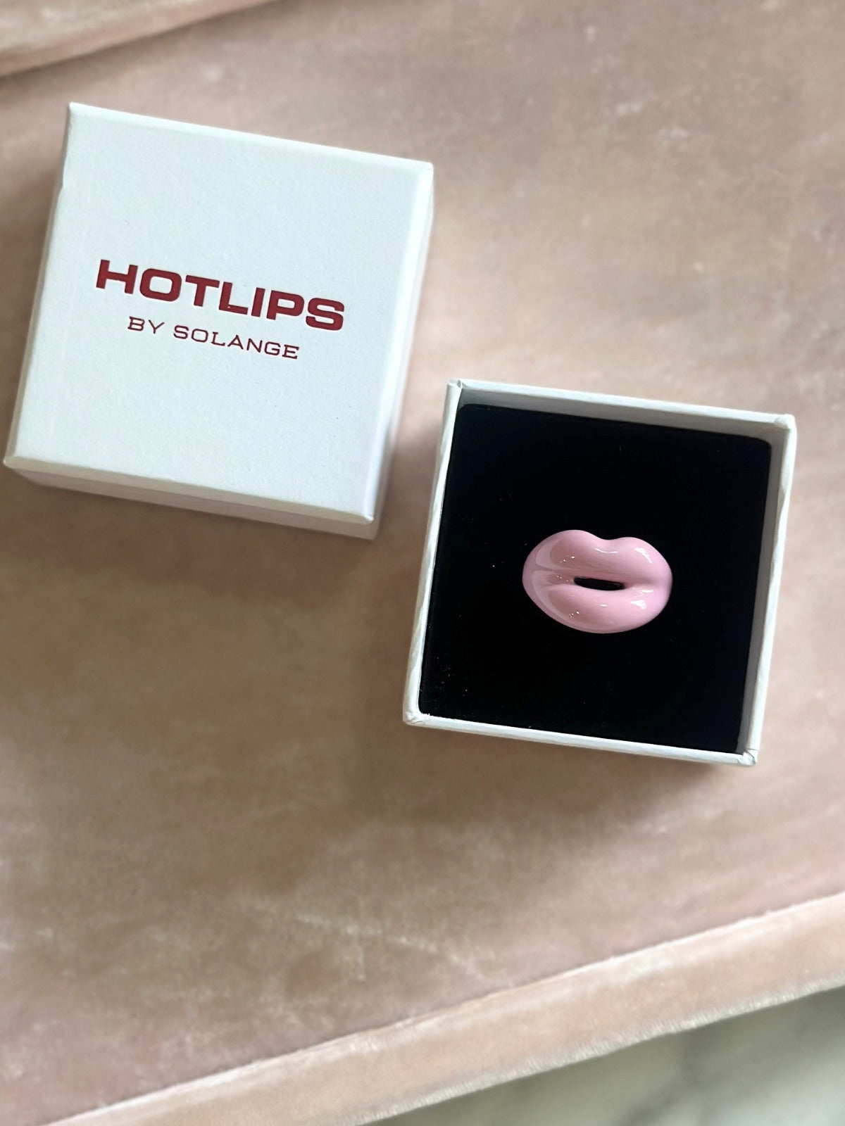 Louise Row featuring Solange Hotlips ring, on box on pink pad
