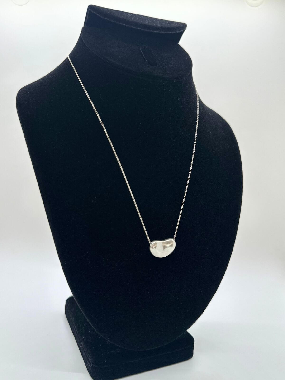 Tiffany Bean necklace on black fixture