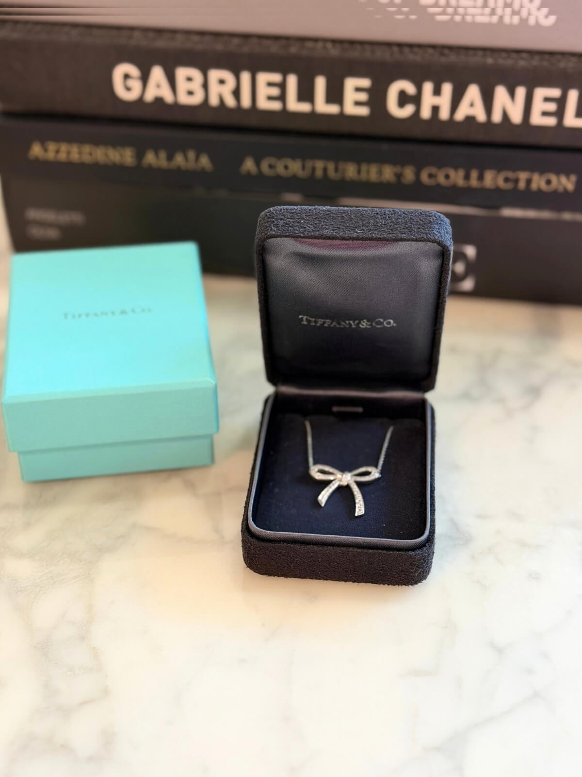 Louise Row featuring Tiffany platinum and diamond bow necklace in box 