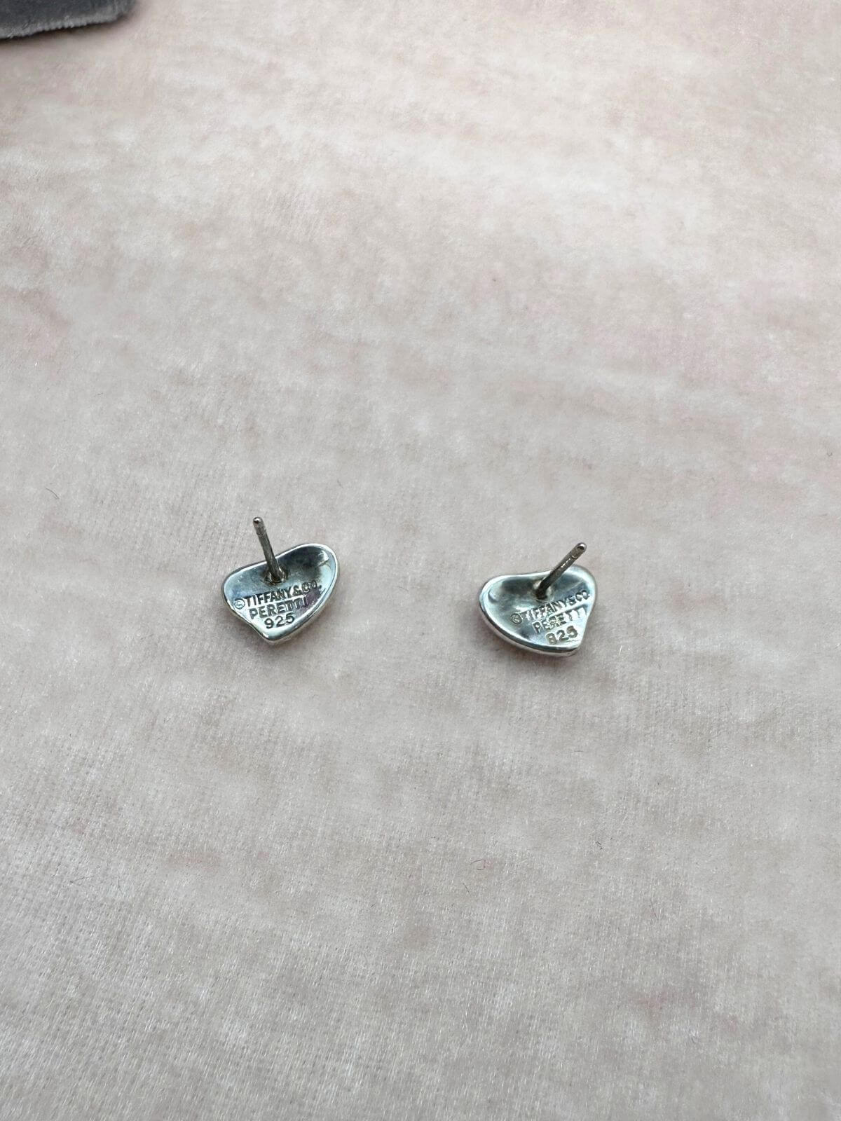 Louise Row Studio featuring Tiffany & Co silver heart stud earrings showing back of earrings with signature.