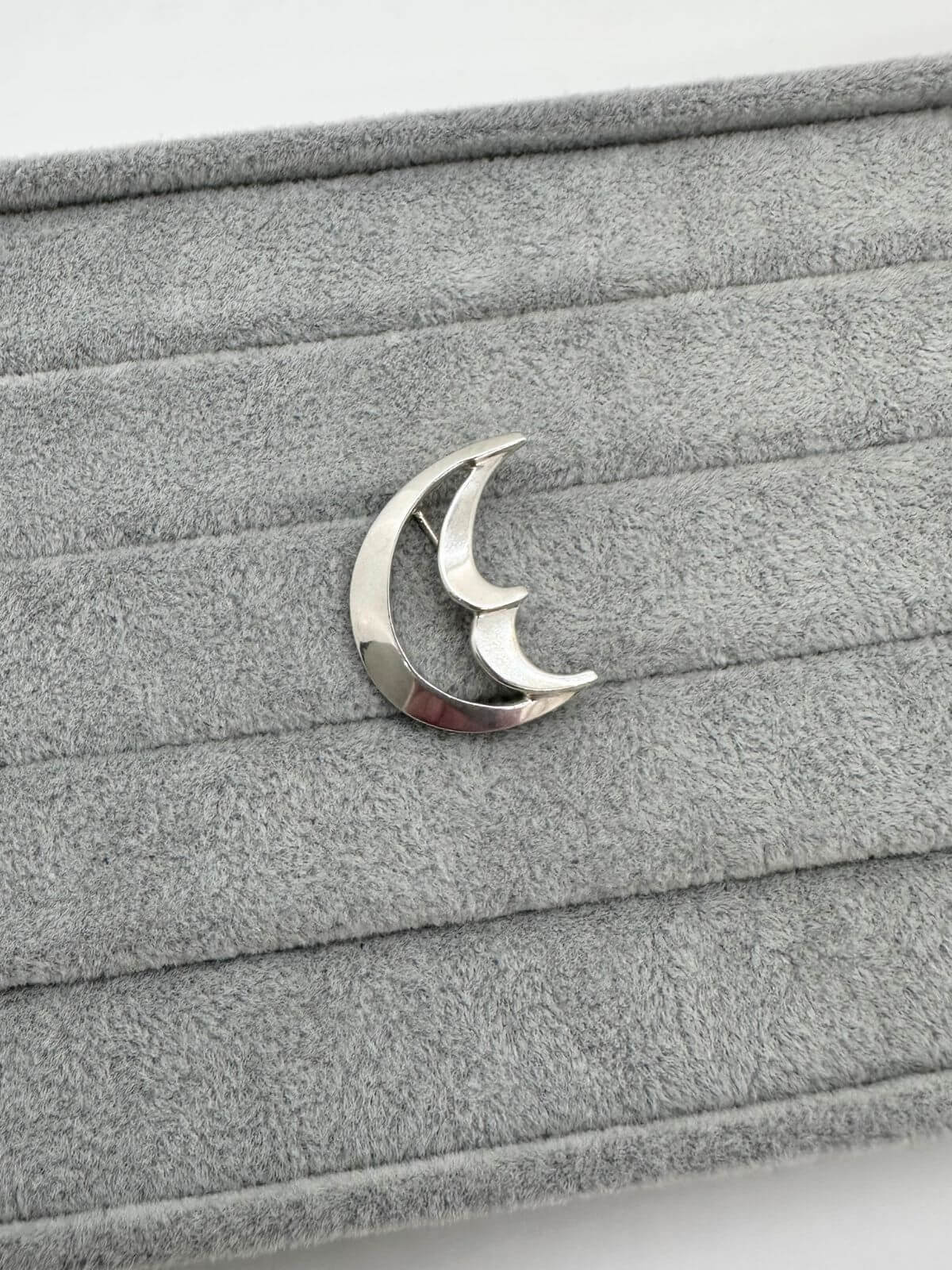 Tiffany moon brooch  on grey background