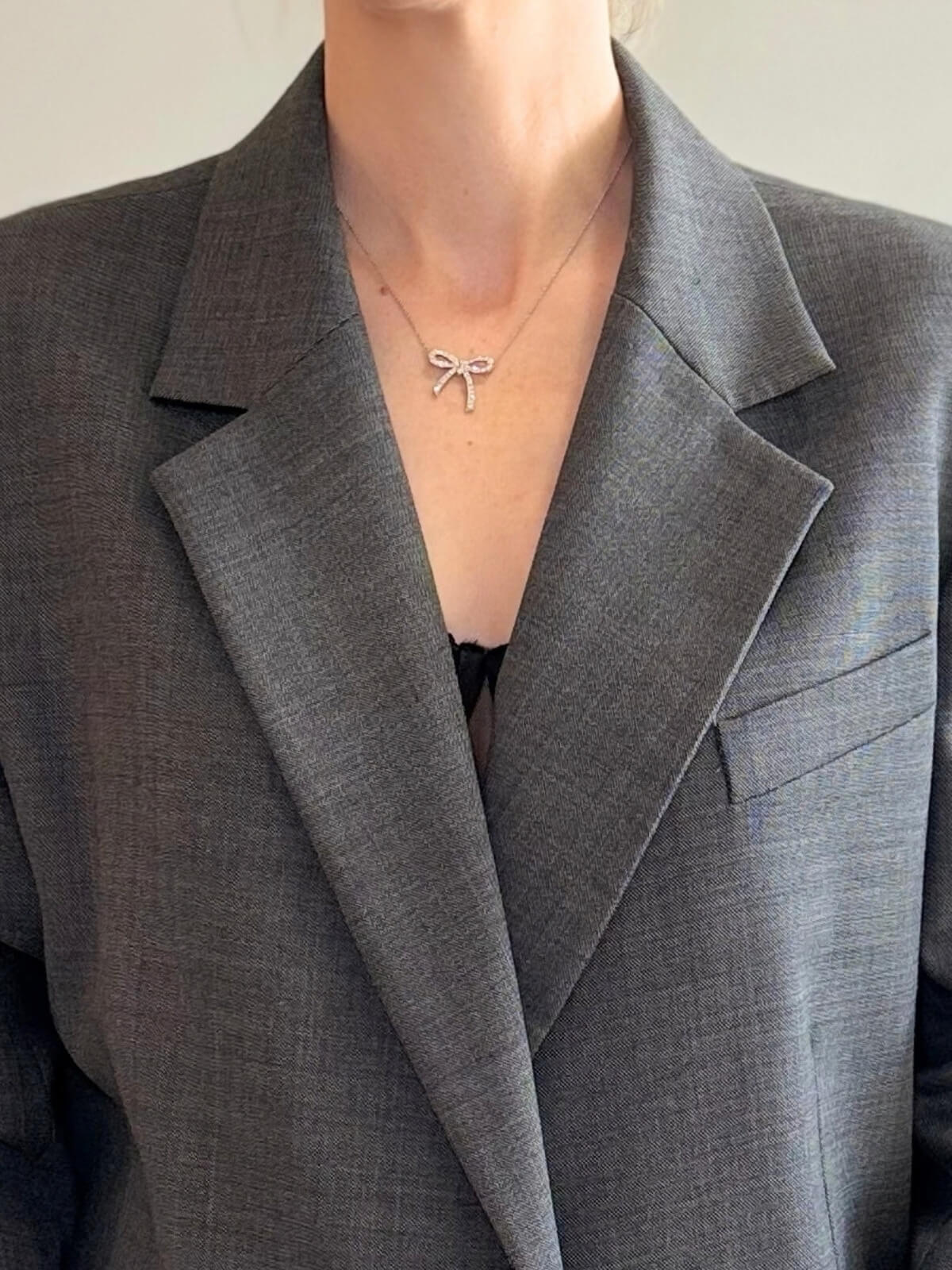 Louise Row featuring Tiffany platinum and diamond bow necklace on model