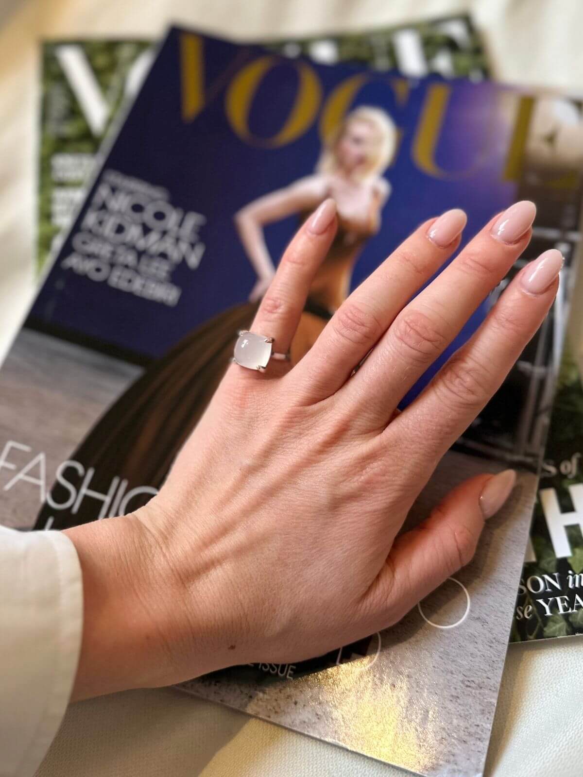 Hand wearing tiffany quartz ring a ring on a Vogue magazine