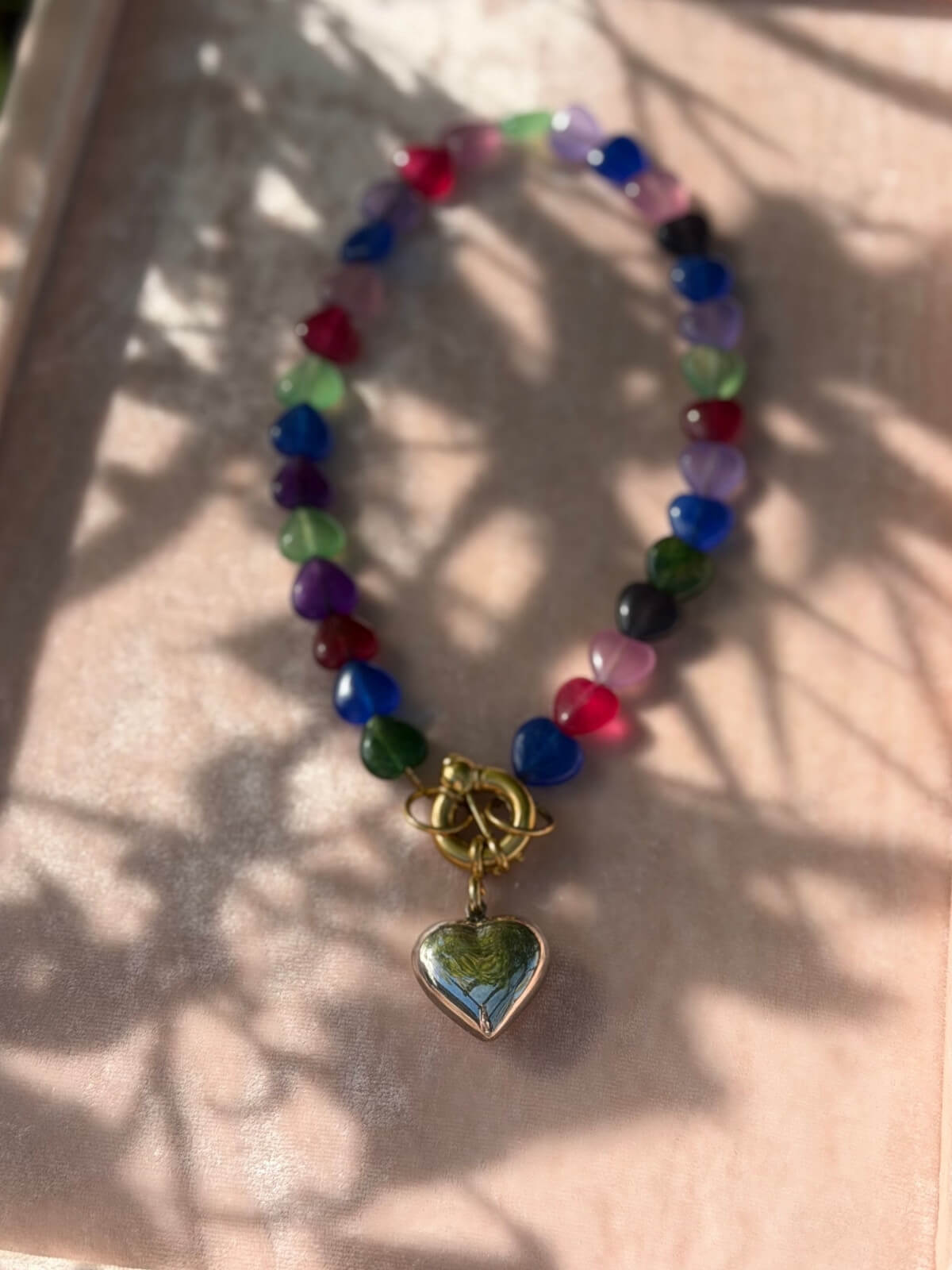 Louise Row featuring Timeless Pearly glass heart necklace on pink tray