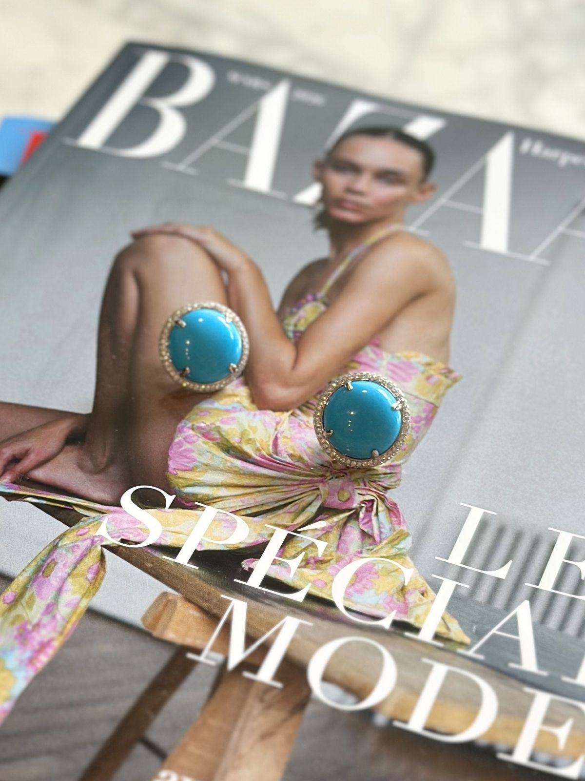 Louise Row Studio featuring Turquoise and Diamond round earrings on magazine.