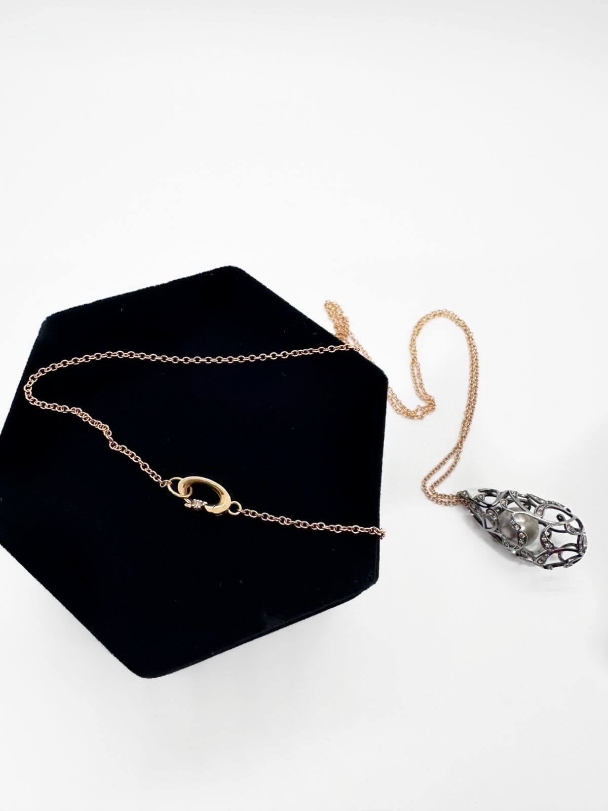 Louise Row Studio featuring Utopia Bolero pearl and diamond necklace black velvet pad and white background