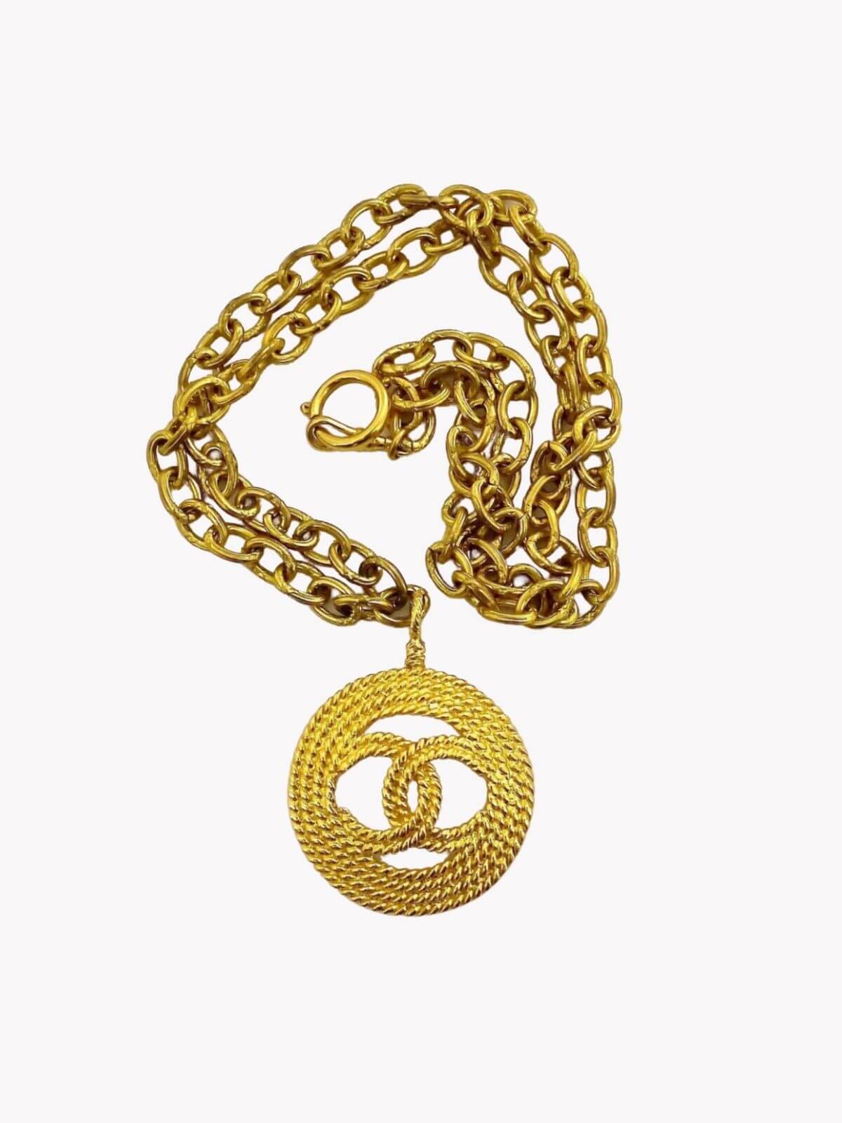 Louise Row Studio featuring Vintage Chanel medallion gold necklace on white background. 