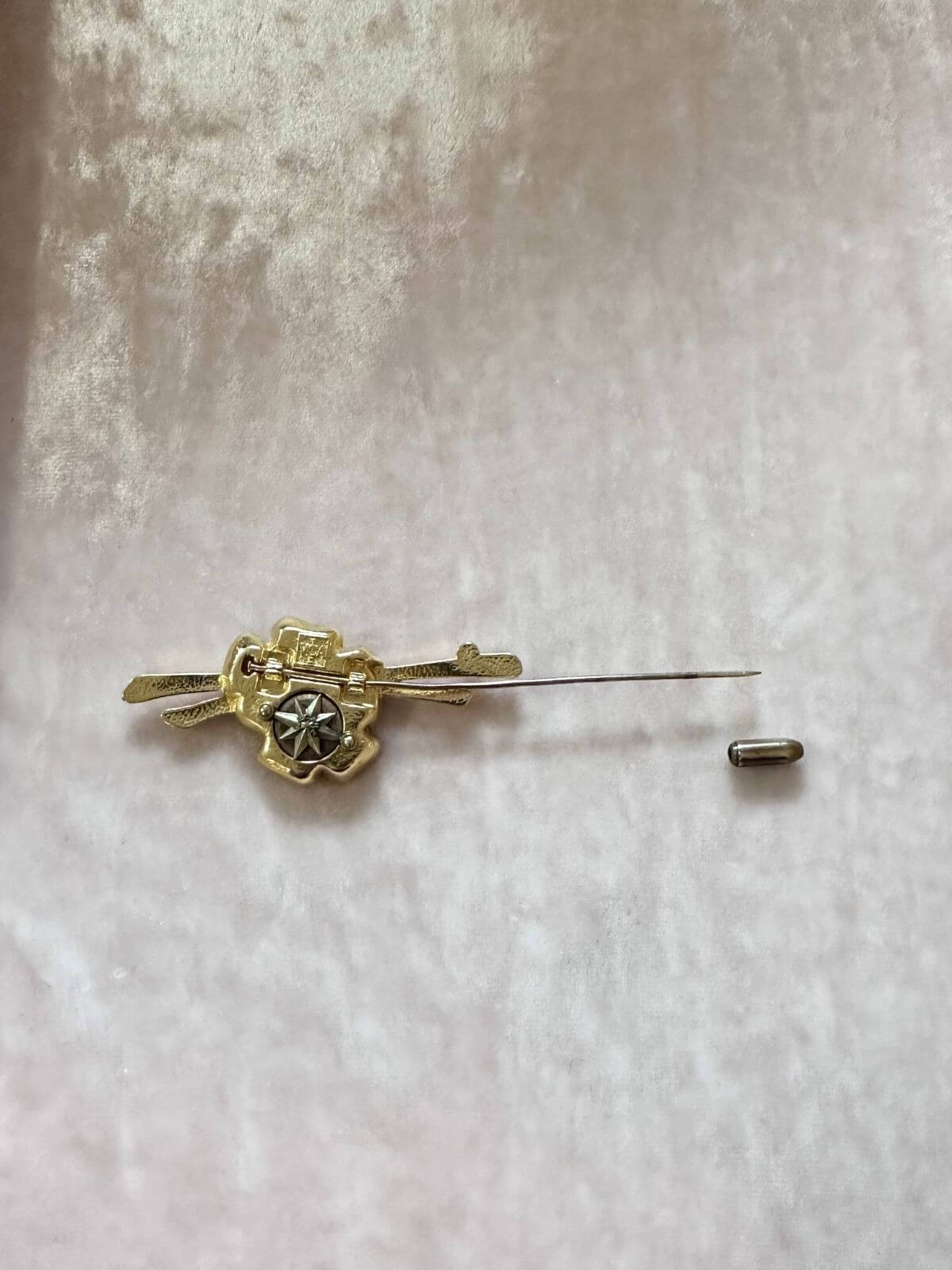 Louise Row Studio vintage Van Cleef & Arpels gold pin brooch on pink display tray.