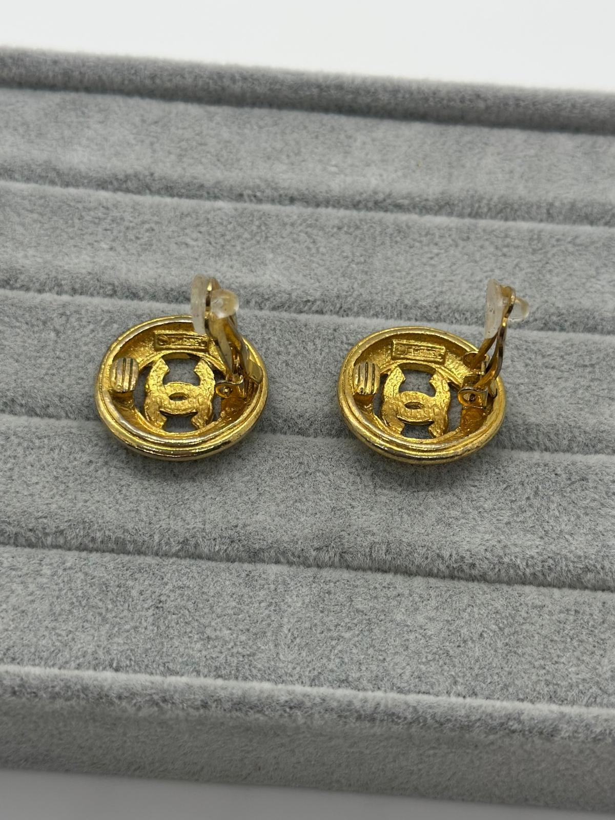 Vintage Gold CC Button earrings on grey background Back view with signature