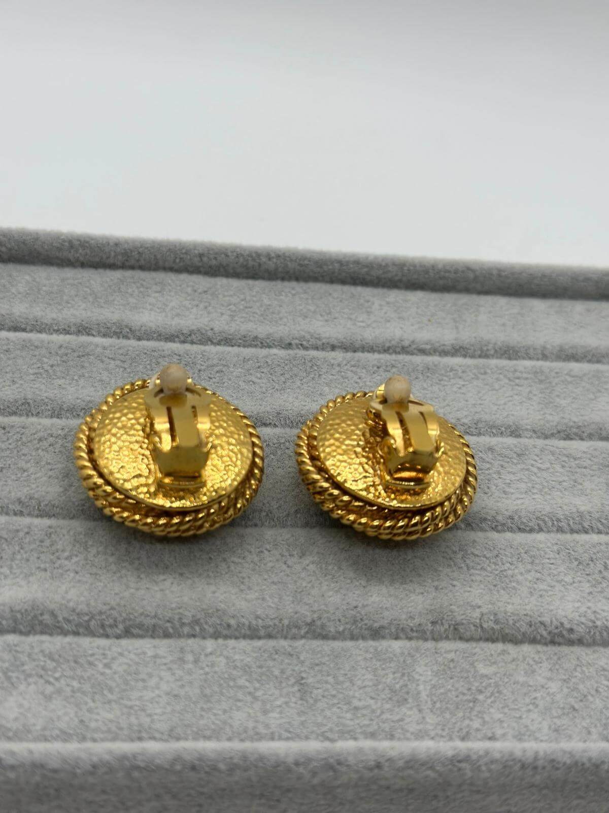 Vintage Changel Pearl and Gold Earring on grey background Back View of clip on