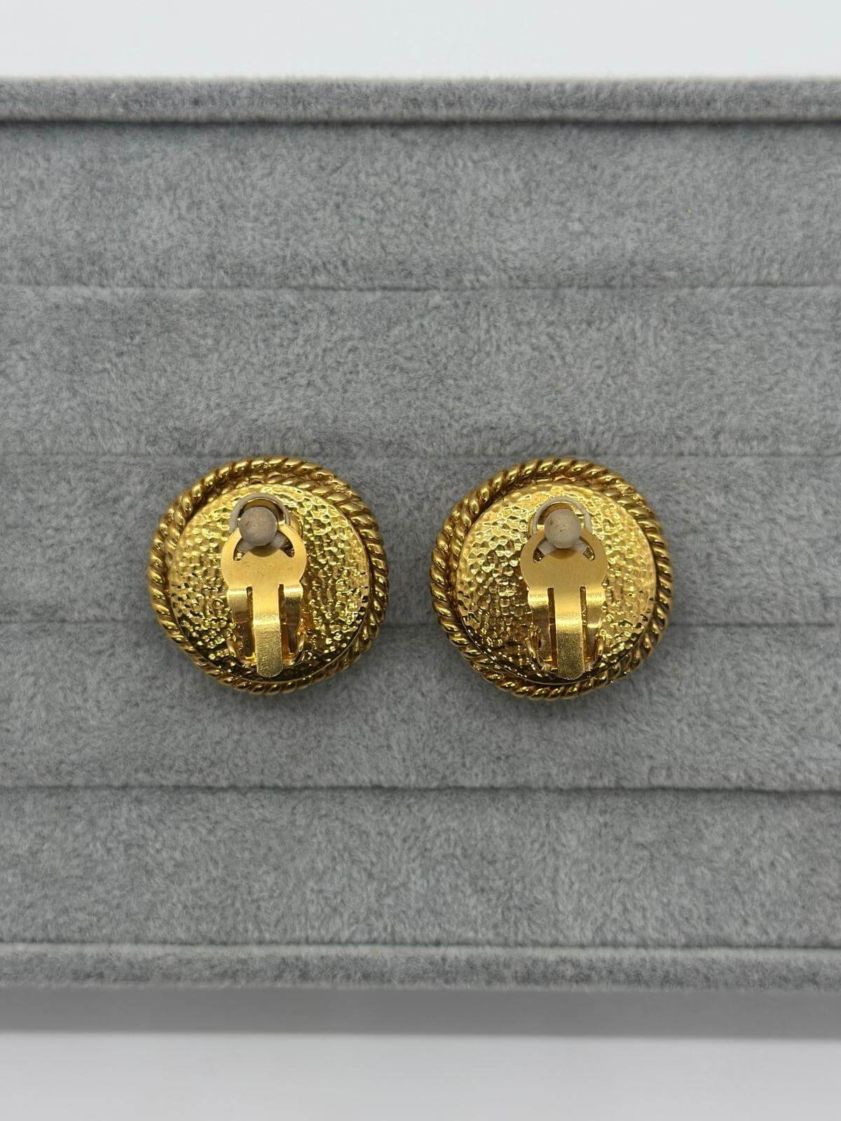 Vintage Changel Pearl and Gold Earring on grey background Back view of clip on