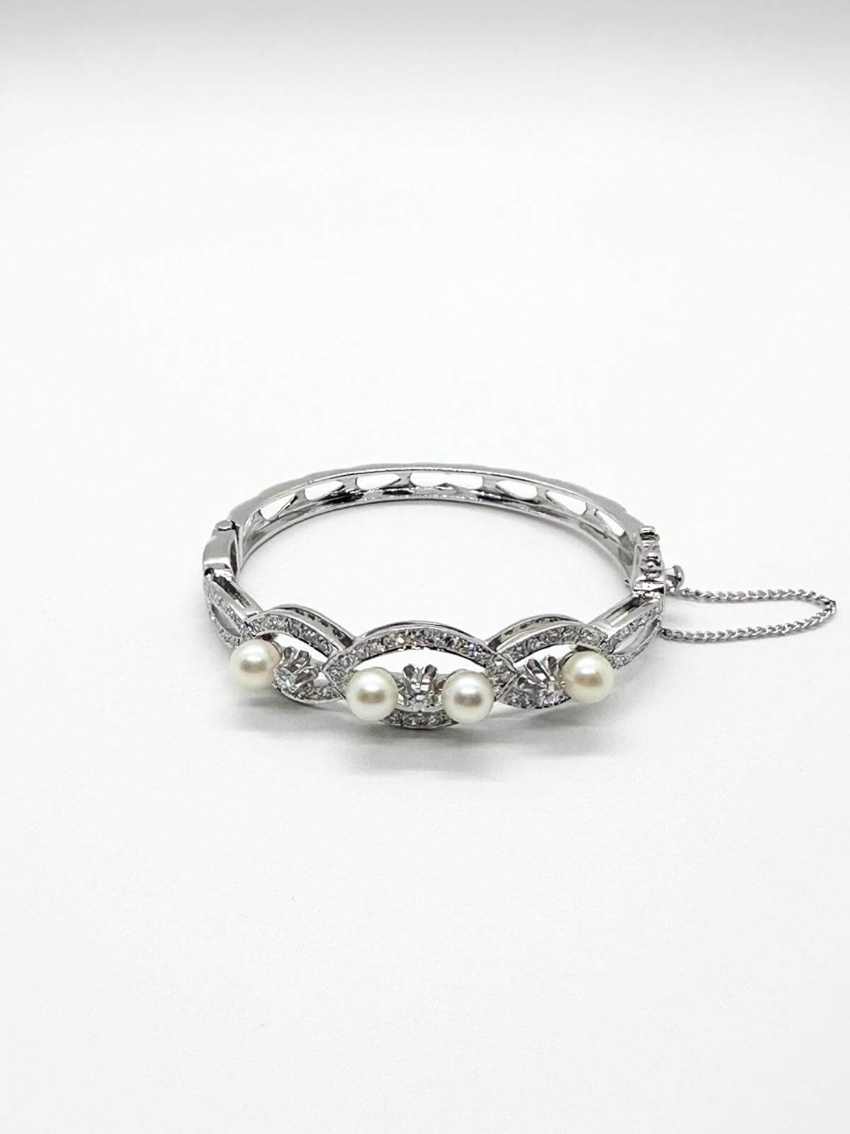White gold and pearl bracelet on white background