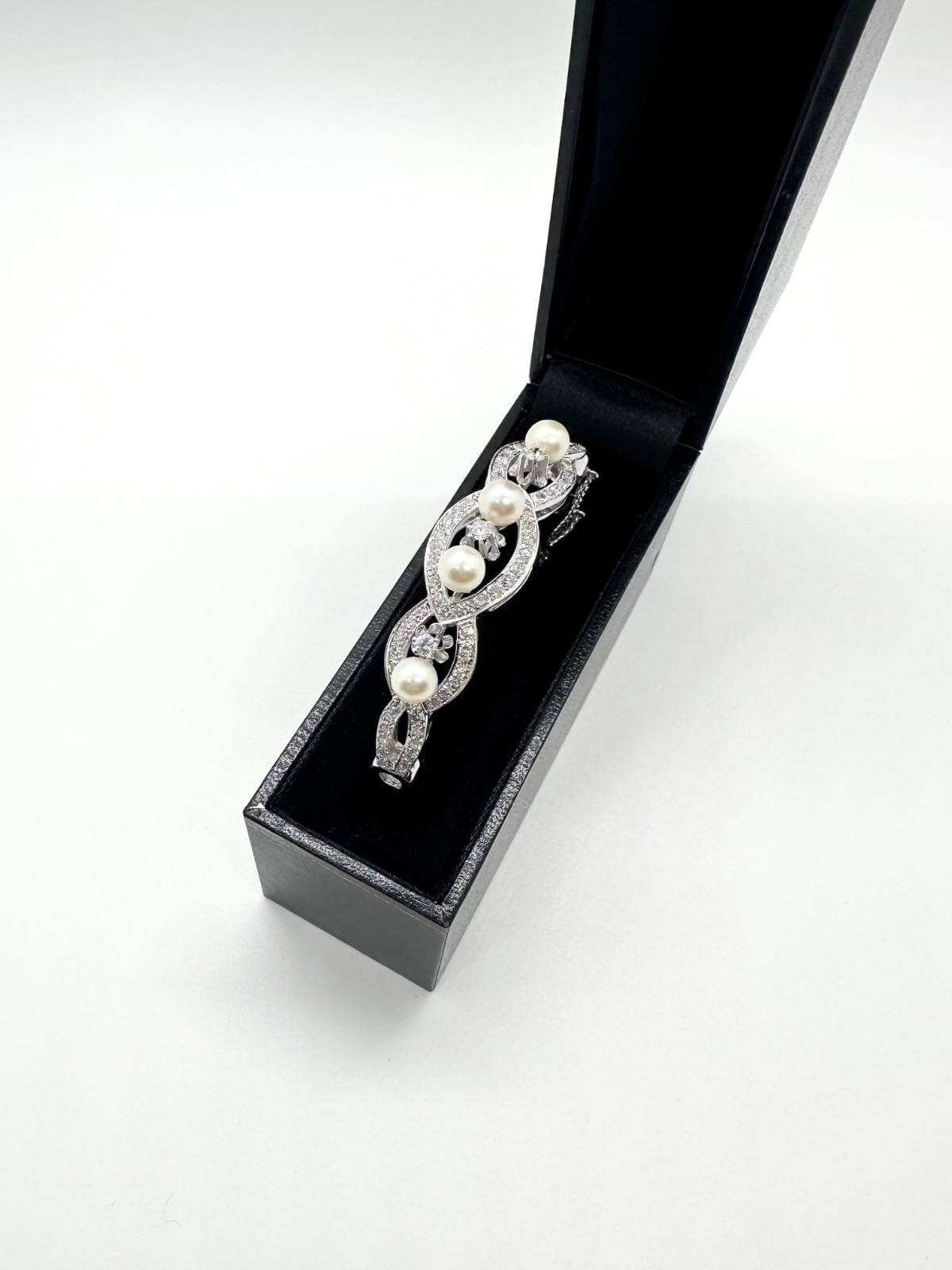  White gold and pearl bracelet on white background in black box